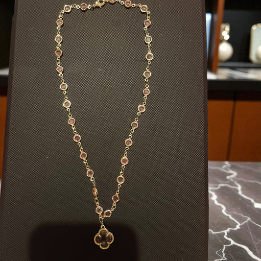Gold chain with pink pendant